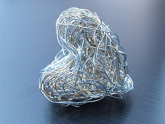Silver Wire Sculpture Forming Heart Shape On Dark Surface