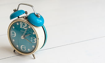 Vintage Blue Alarm Clock on White Wooden Background