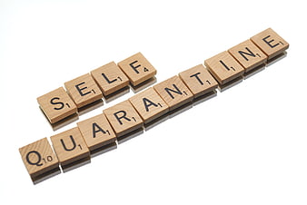 Wooden Scrabble Tiles Spelling Self Quarantine on White Background