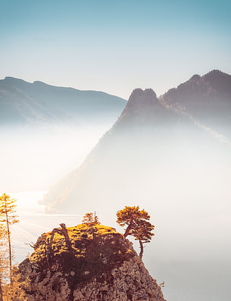Misty Alpine Mountain Landscape with Golden Autumn Trees and Lake
