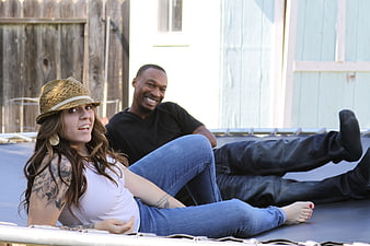 Happy couple relaxing on trampoline outdoors