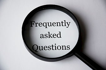 Magnifying glass over frequently asked questions text