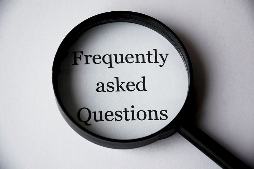 Magnifying glass over frequently asked questions text