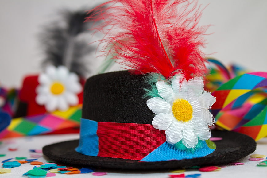 Black Carnival Hat With Red Feathers And White Flower Decoration