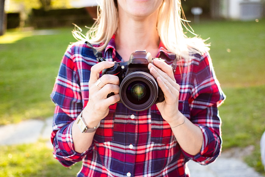 Woman Photographer Holding DSLR Camera Outdoors