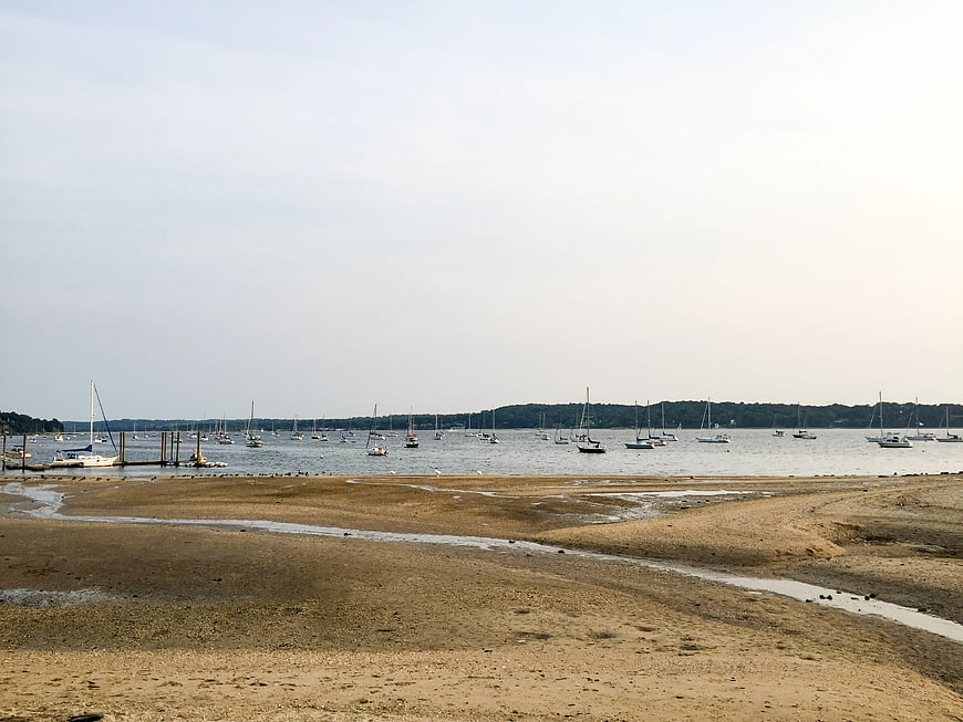 Sandy Beach at Low Tide with Moored Sailboats