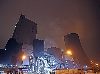 Night view of industrial power plant with cooling tower