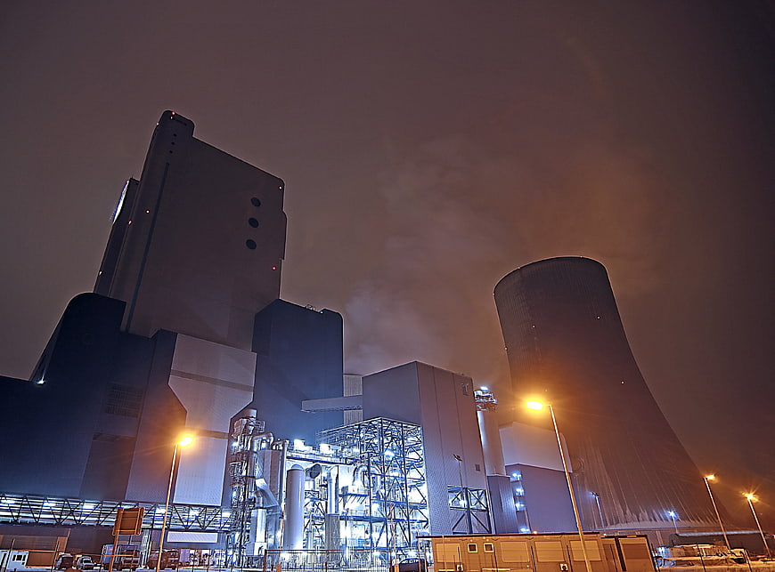 Night view of industrial power plant with cooling tower