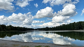 Serene Lake Landscape with Cloud Reflections and Blue Sky