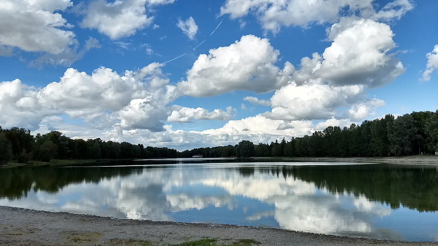 Serene Lake Landscape with Cloud Reflections and Blue Sky