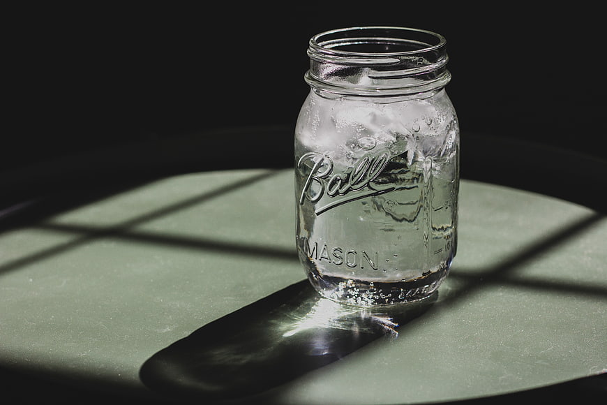 Ball Mason Jar with Ice and Water in Dramatic Light