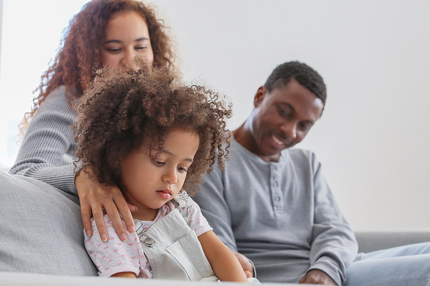 African American Family Relaxing Together on Sofa at Home