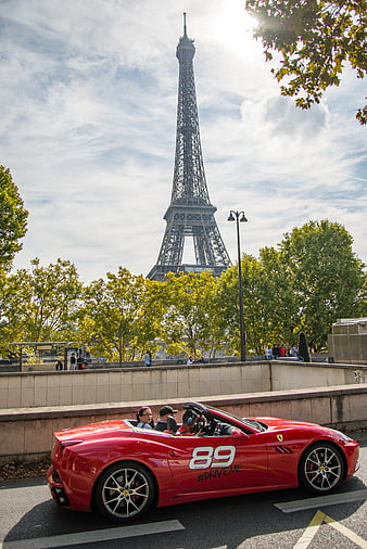 Red Ferrari Convertible Driving Past Eiffel Tower in Paris