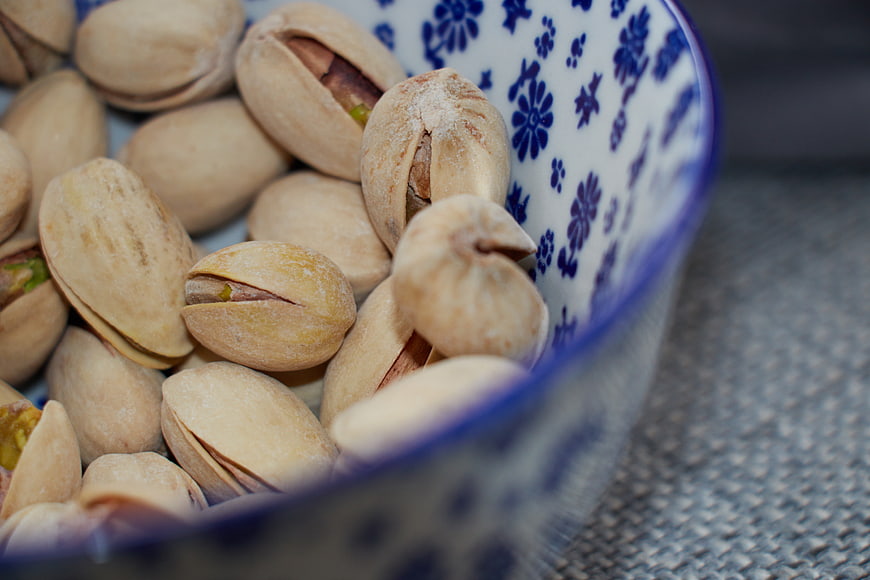 Close-up of Roasted Pistachios in Blue Patterned Bowl