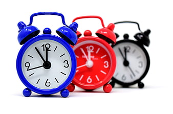 Colorful alarm clocks on white background