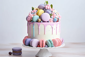 Pastel drip cake with colorful macarons on white stand