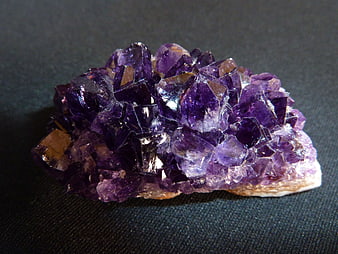 Raw Amethyst Crystal Cluster On Dark Textured Background