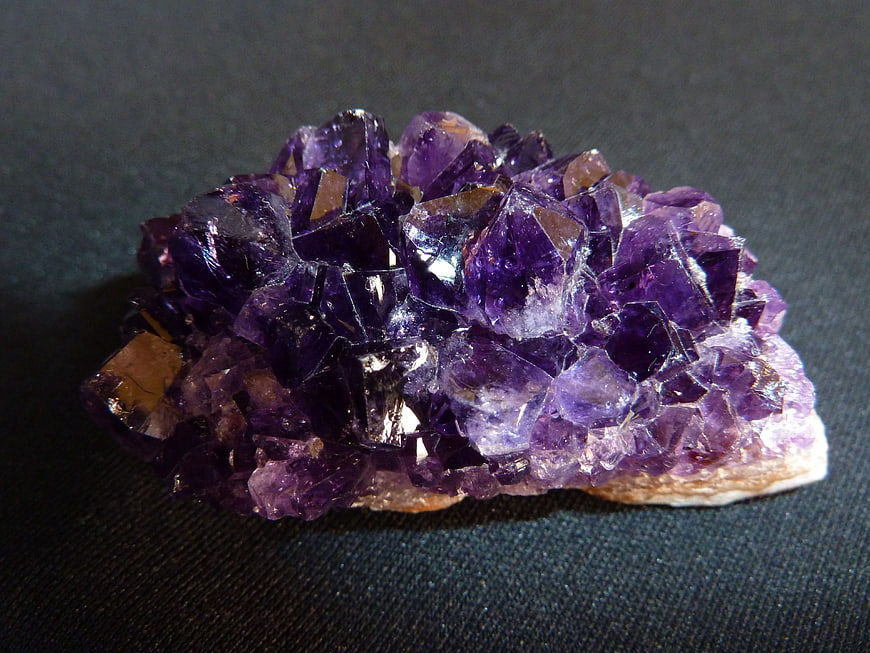 Raw Amethyst Crystal Cluster On Dark Textured Background