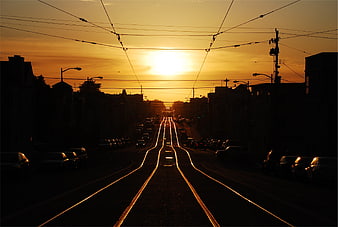 Golden Sunset Over City Street with Tram Tracks