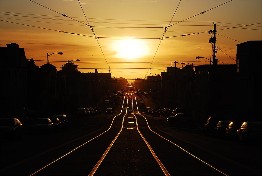 Golden Sunset Over City Street with Tram Tracks