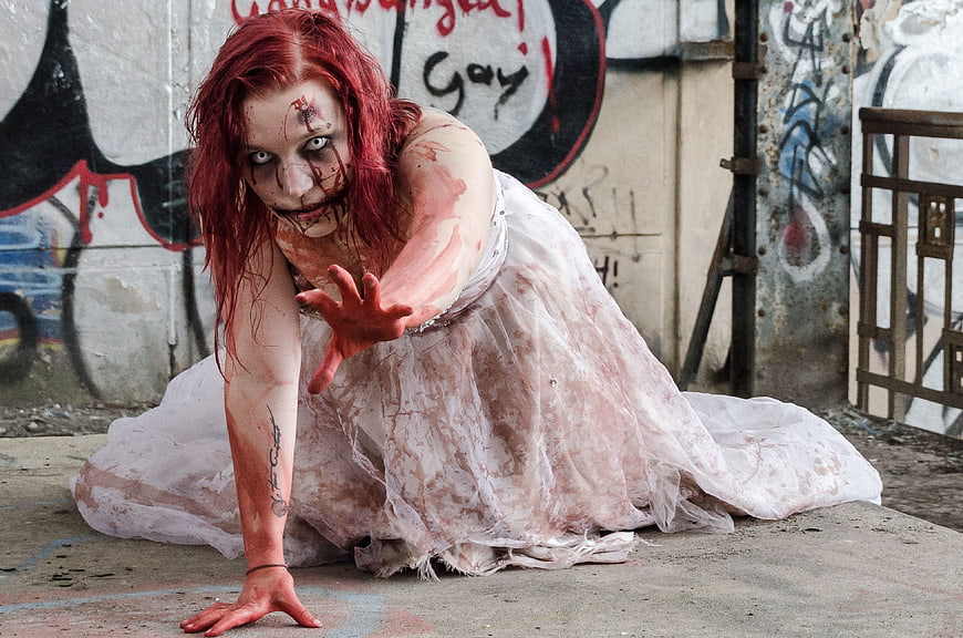 Bloody Zombie Woman Crawling in Urban Graffiti Setting
