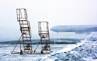 Aeroflot airplane landing on snowy runway with orange stairs