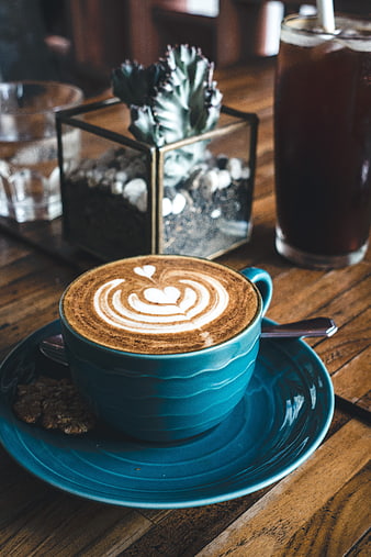 Blue Cup of Cappuccino with Latte Art on Wooden Table