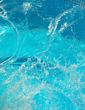 Close-up of vibrant blue pool water splash with bubbles