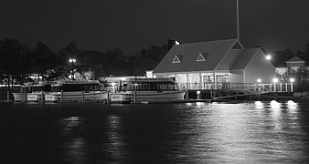 Night view of docked boats and waterfront building
