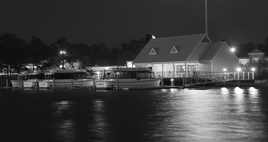 Night view of docked boats and waterfront building