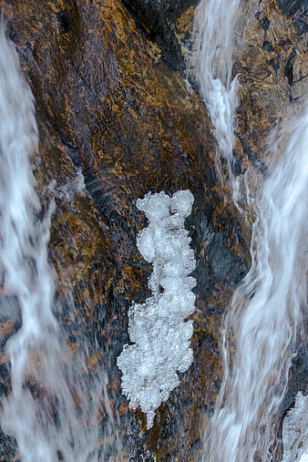 Frozen Ice Formation on Wet Rocks with Flowing Water