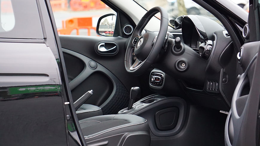 Modern car interior with black dashboard and steering wheel
