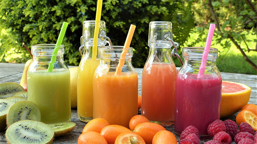 Colorful Fresh Fruit Juices in Glass Bottles with Straws