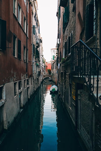 Narrow Venice Canal with Reflections and Moored Boat