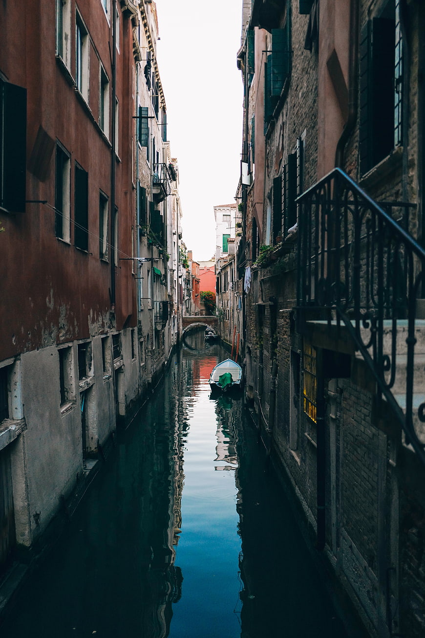 Narrow Venice Canal with Reflections and Moored Boat