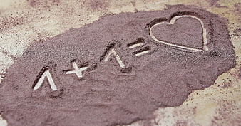Love Equation Written in Chocolate Powder on Wooden Surface