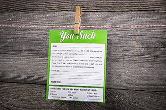 Humorous You Suck Letter Template on Wooden Background