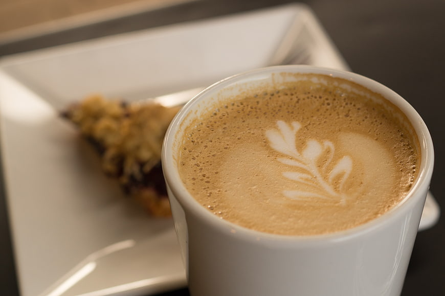Close-up of Cappuccino with Latte Art and Pastry