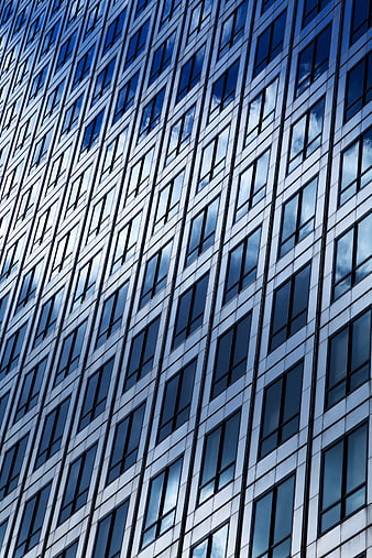 Modern Skyscraper Facade with Blue Glass Windows and Cloud Reflections