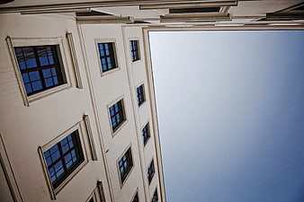 Low angle view of classical building facade against blue sky