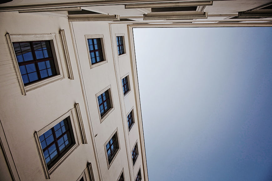 Low angle view of classical building facade against blue sky