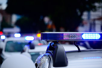 Close-up of flashing blue police car siren lights at night