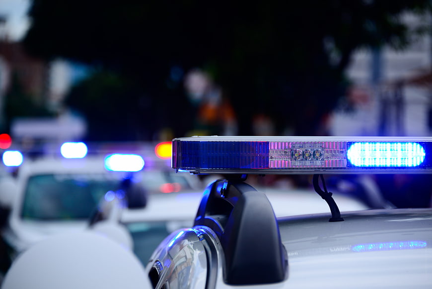 Close-up of flashing blue police car siren lights at night
