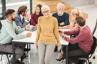 Senior businesswoman smiling in office meeting