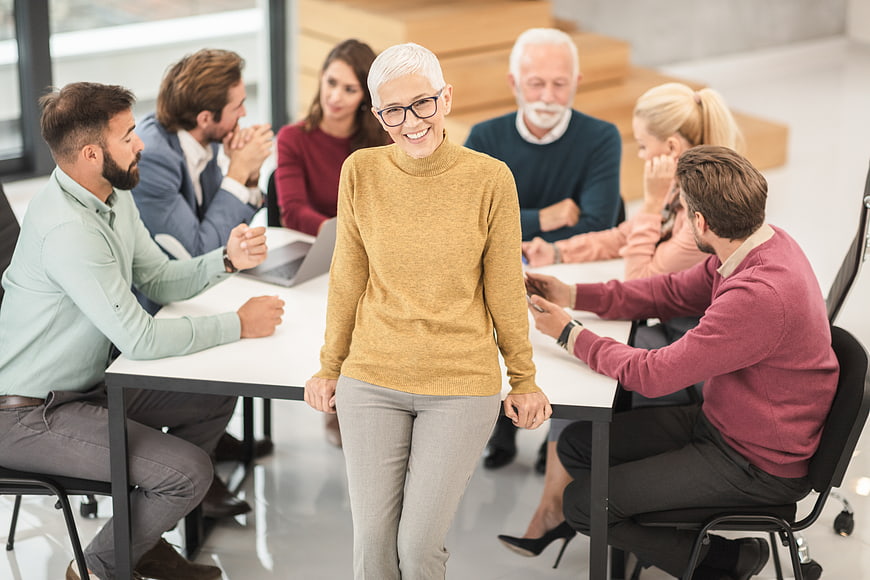 Senior businesswoman smiling in office meeting