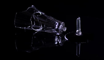 Broken Champagne Glass Shards on Black Reflective Surface