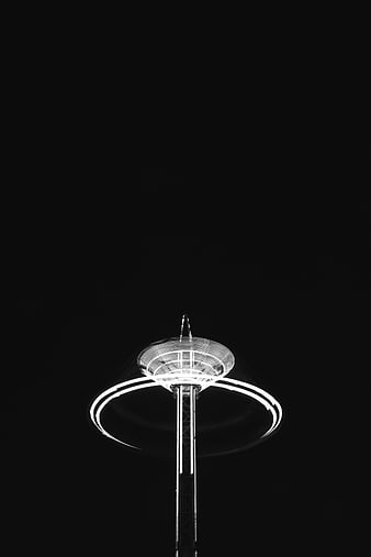 Black and white night photo of illuminated observation tower