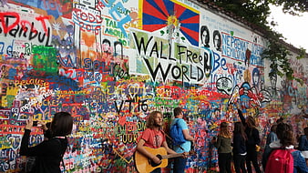 Man Playing Guitar At Colorful Lennon Wall In Prague