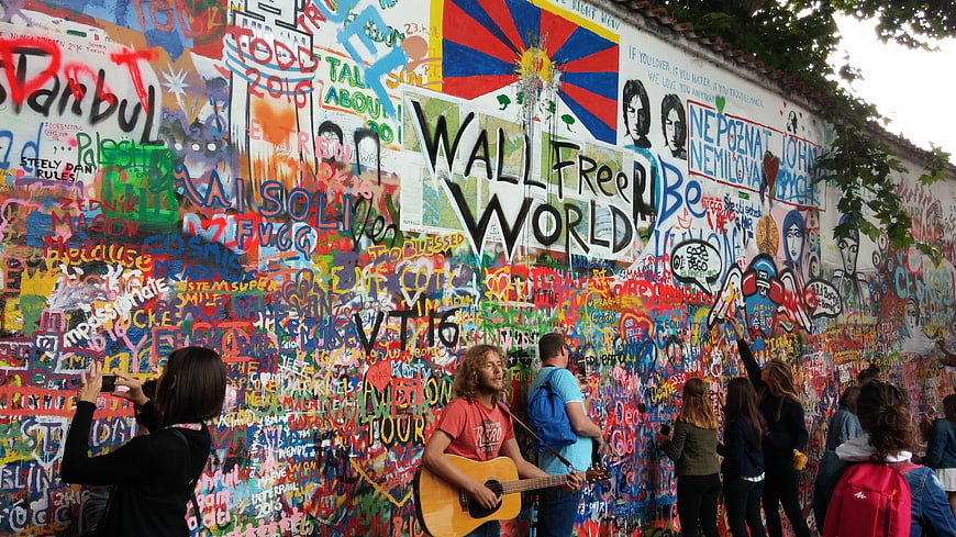 Man Playing Guitar At Colorful Lennon Wall In Prague