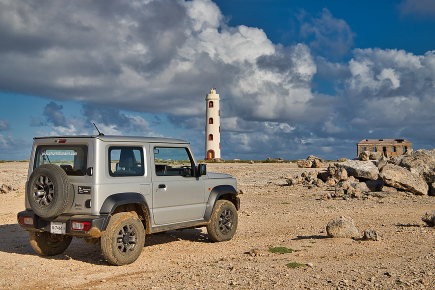 Silver SUV parked near lighthouse on Bonaire
